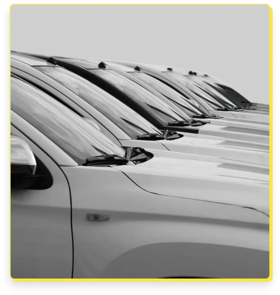 fleet maintenance, auto repair in Lansing, MI at Jerry's Automotive. A row of parked cars with silver exteriors, featuring clean windshields and visible side mirrors, aligned in a neat formation against a plain gray background.