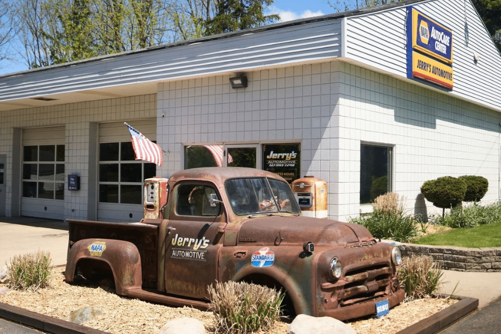 Jerry's Automotive Addresses Vehicle Battery Degradation Risks Caused by Seasonal Heat Waves. Image of Dodge pickup truck branded with "Jerry's Automotive" parked as a display in front of a NAPA AutoCare Center building.