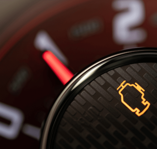 Check engine light diagnostics in Lansing, MI by Jerry's Automotive. Image showing a close-up of an illuminated check engine light on a vehicle dashboard, emphasizing the importance of timely diagnostics and repair.
